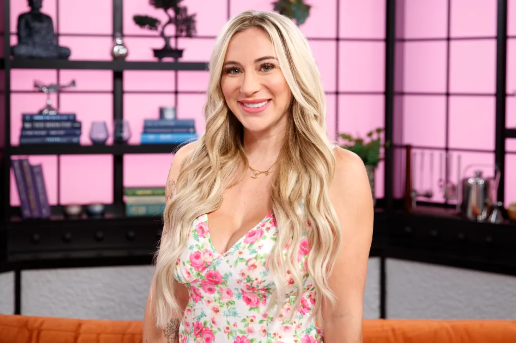 Tammy Thompson smiling while wearing a floral dress.