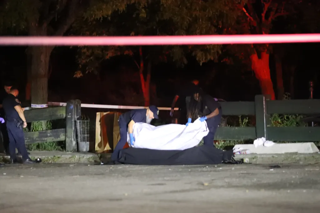 Police officers investigate a crime scene where an unidentified female was found dead in Sheepshead Bay, Brooklyn.