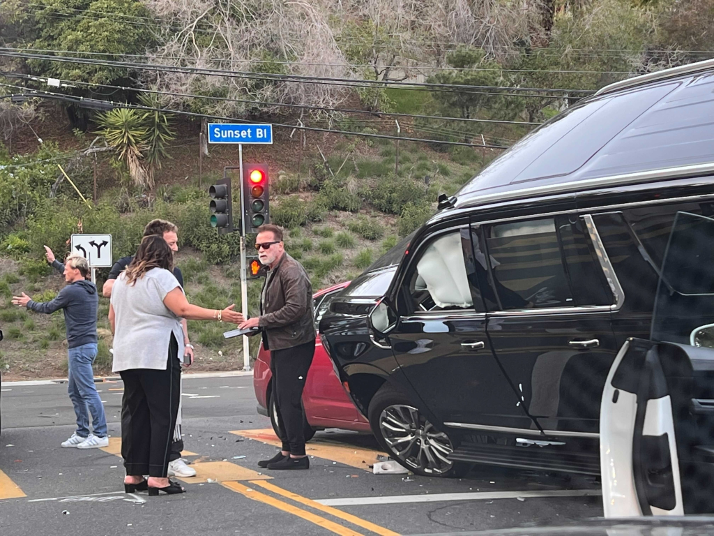 Arnold Schwarzenegger talking to people near a traffic accident on Sunset Boulevard involving his SUV.