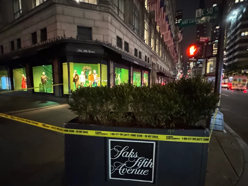 Saks Fifth Avenue storefront with crime scene tape across a planter.