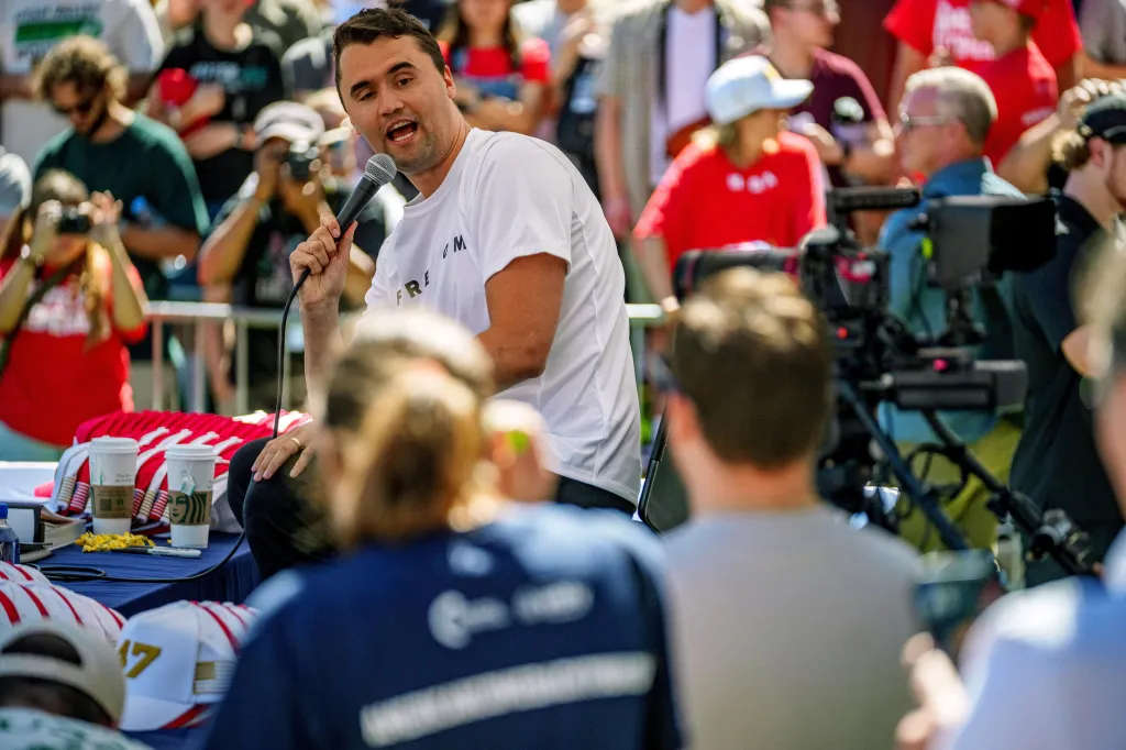Charlie Kirk speaks into a microphone at a Utah Valley University event.