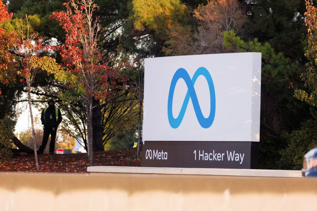A security guard stands near the Meta sign outside the company's headquarters.