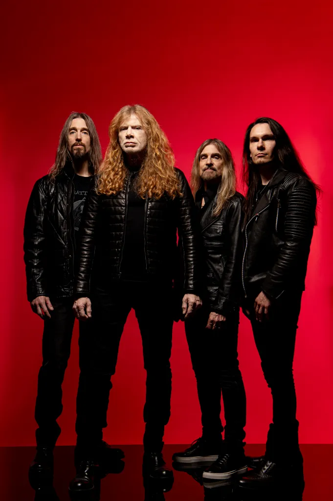 Studio portrait of the heavy metal band Megadeth against a red background.