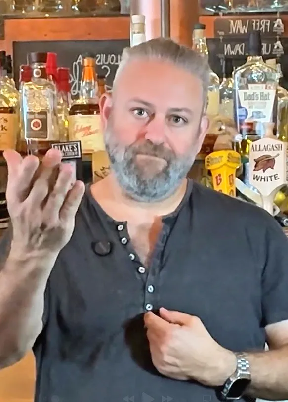 Aaron Robins, owner of Boneyard Bistro, in front of a bar.