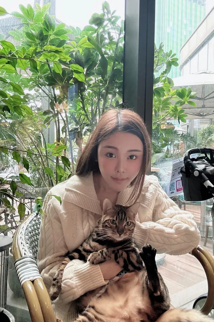Abby Choi poses with her cat.