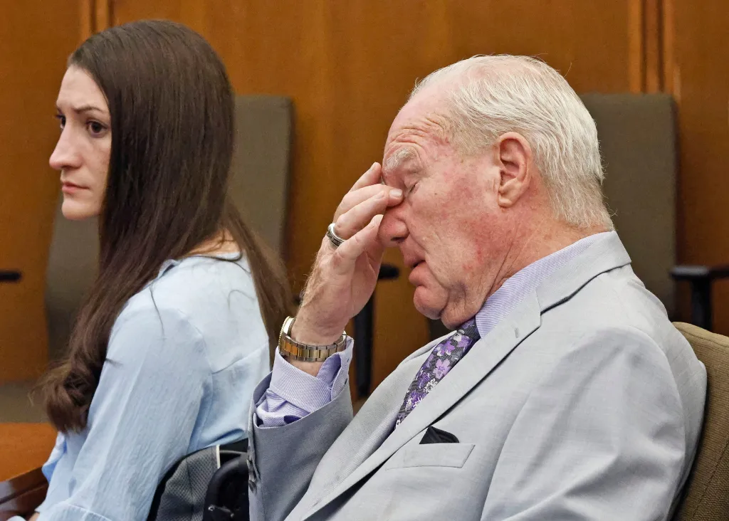 Lindsay Clancy and attorney Kevin Reddington watch jurors in court.