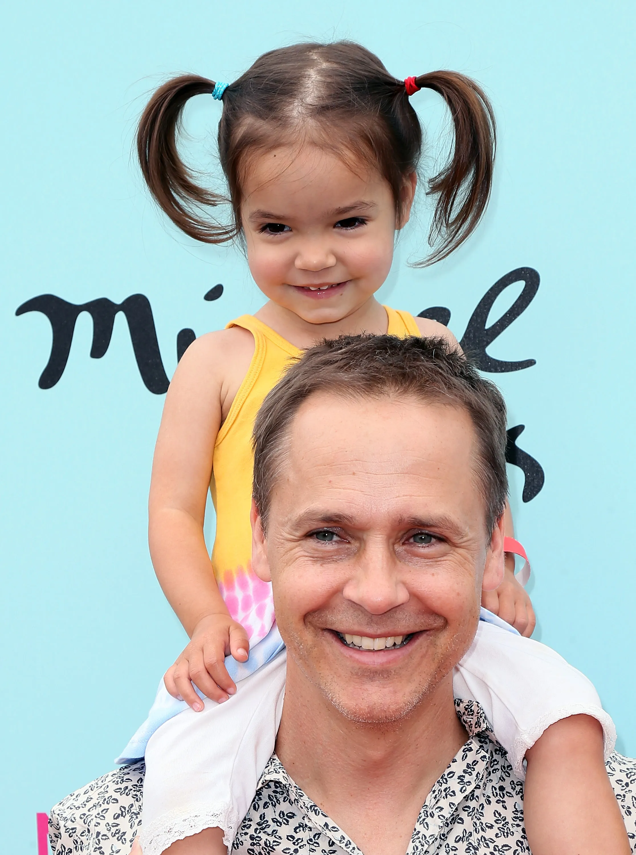 Actor Chad Lowe giving his young daughter Fiona Lowe a piggyback ride at an event.