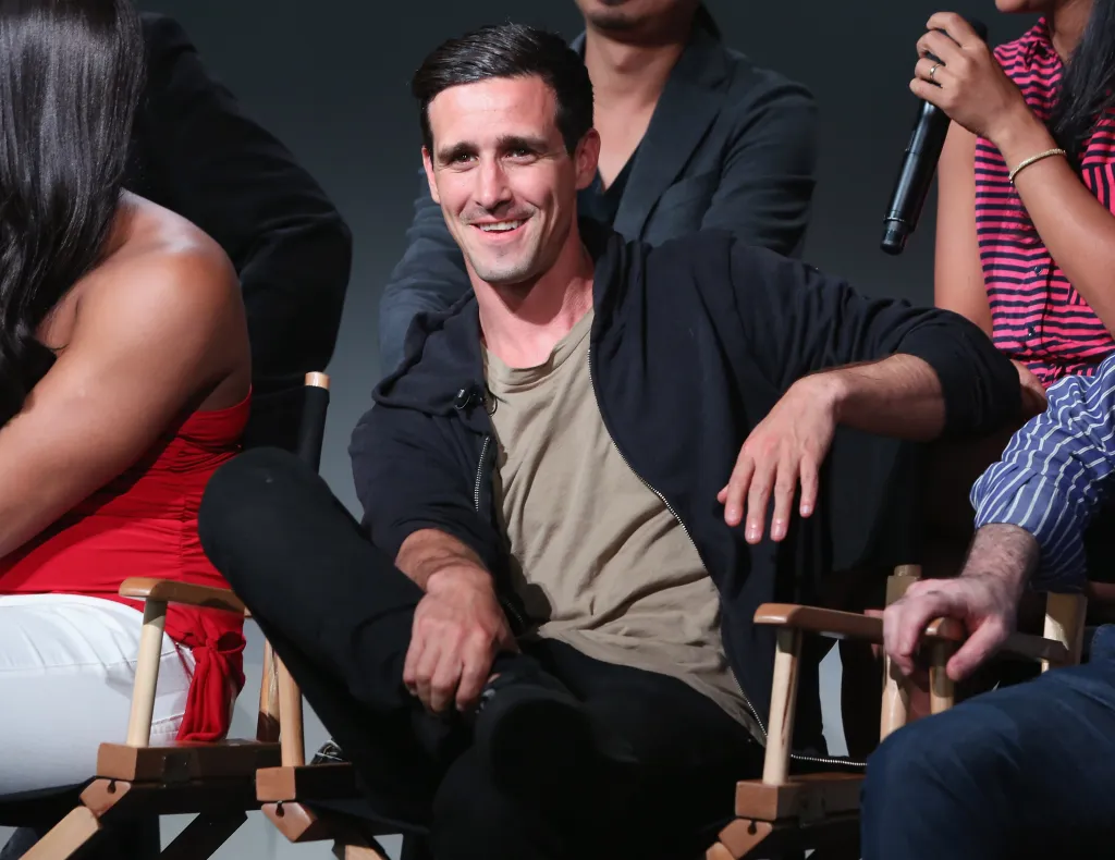 Actor James Ransone smiling while sitting on a chair.