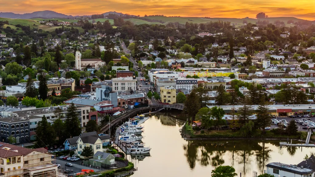 Aerial view of the Petaluma River and historic downtown Petaluma at sunset.