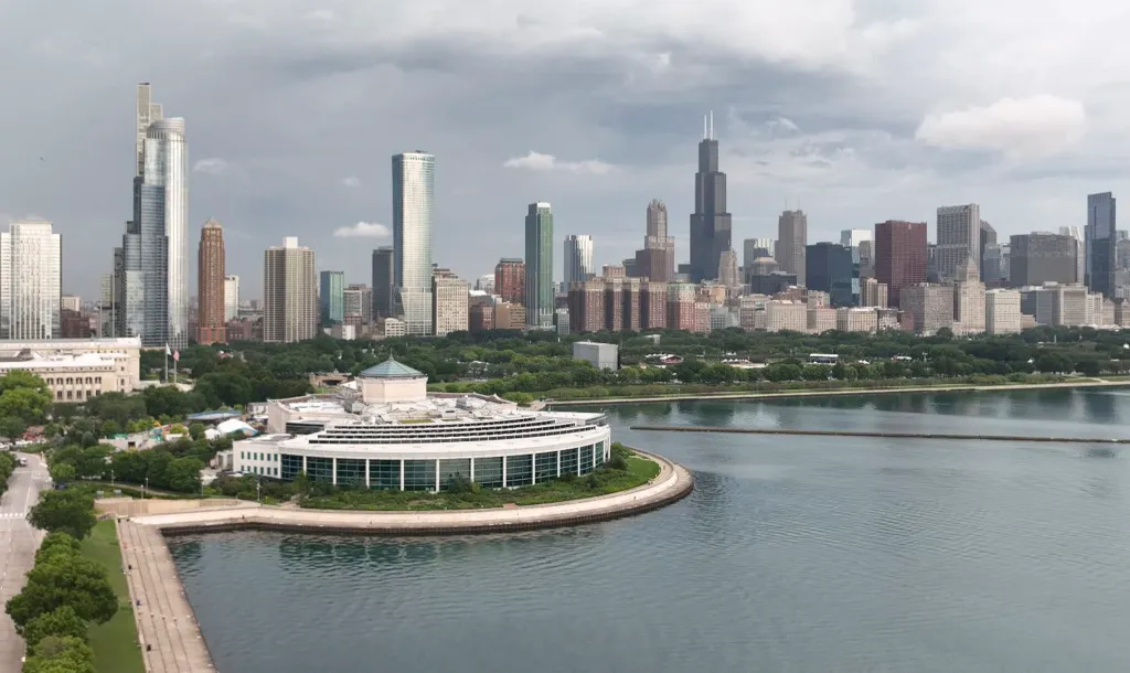 Aerial view of Shedd Aquarium on Lake Michigan in Chicago, with the city skyline in the background.