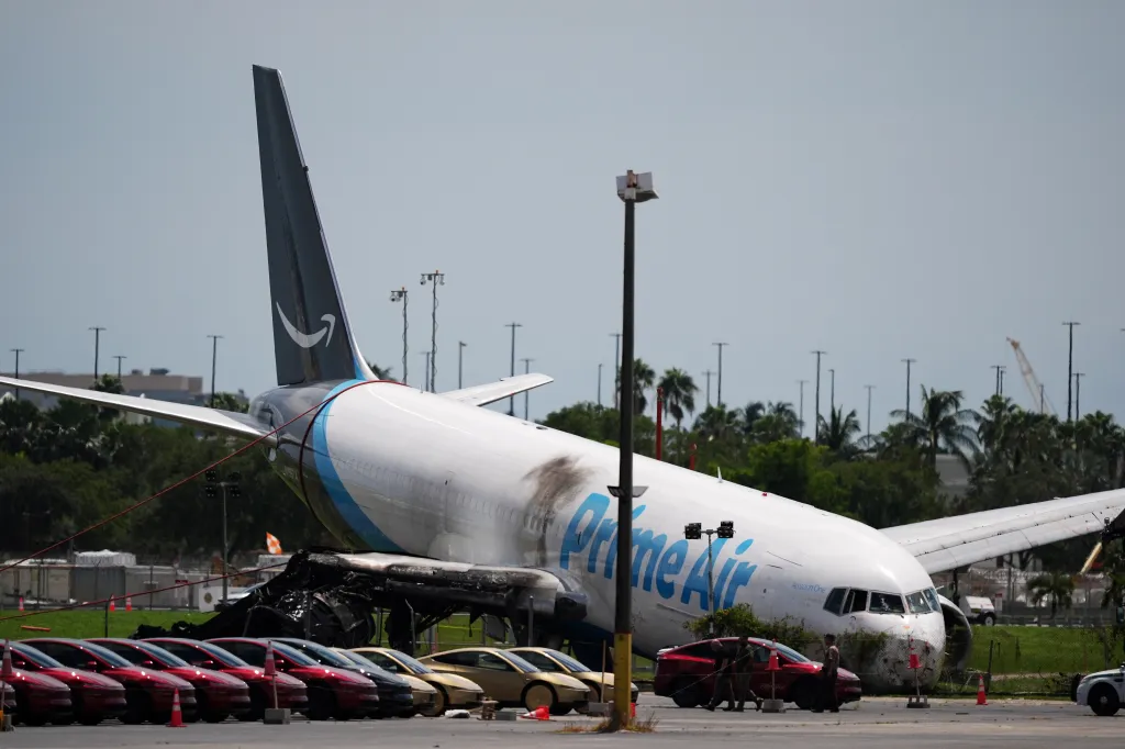 An Amazon cargo plane lies damaged near a parking lot two days after overshooting a runway at Miami International Airport on Sept. 8, 2026, in Miami.