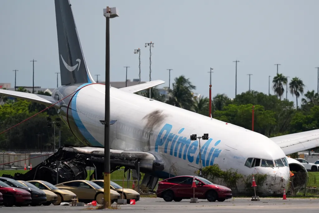 An Amazon cargo plane damaged after overshooting a runway at Miami International Airport.