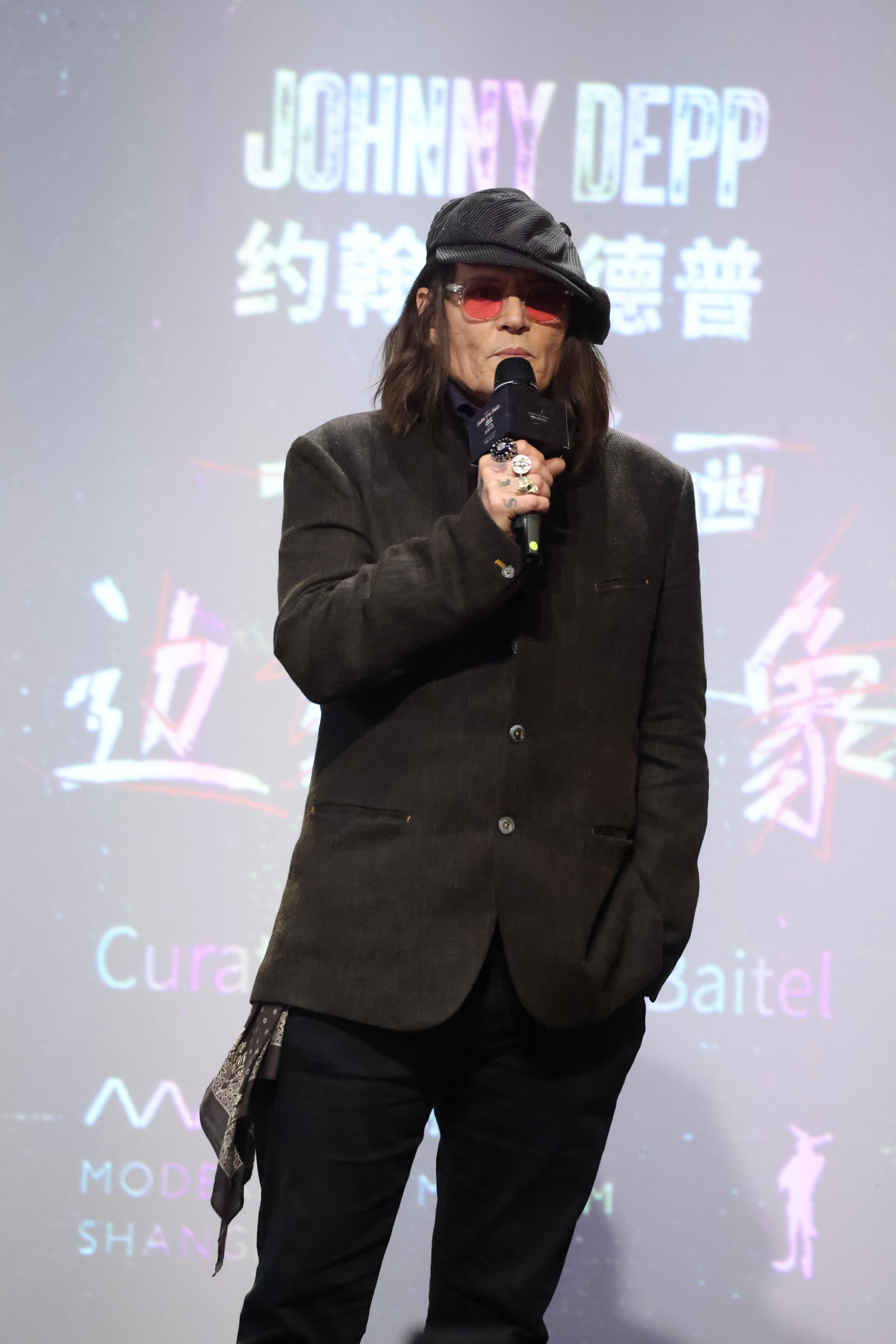 Johnny Depp speaking at an event in Shanghai.