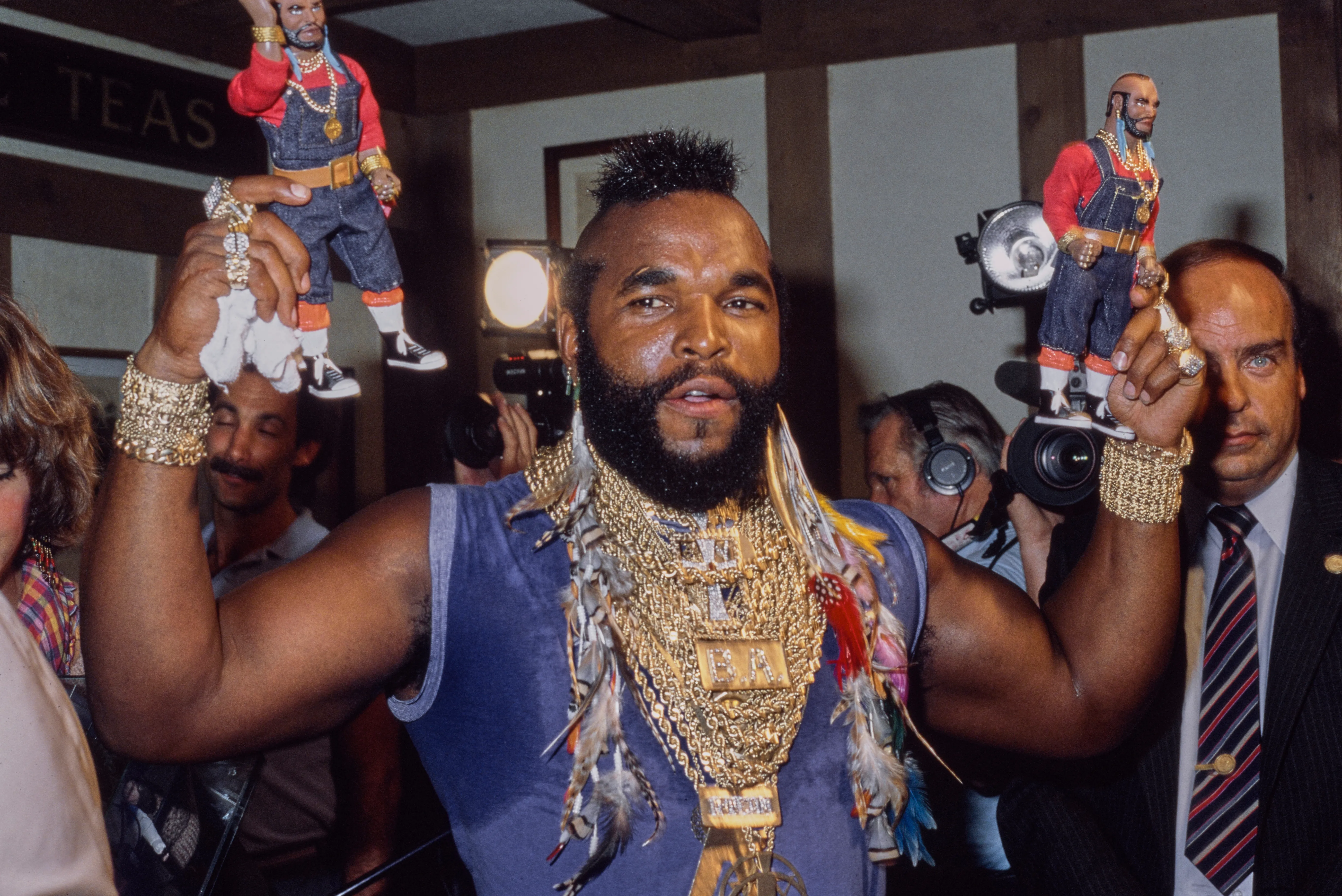 Mr. T holding two Galoob action figures of himself.