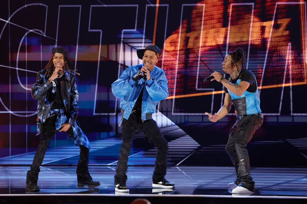 Three men of CitiLimitz perform on stage.