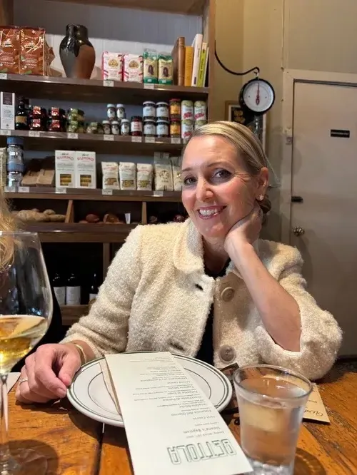Amy Hillyard smiling while seated at a table.