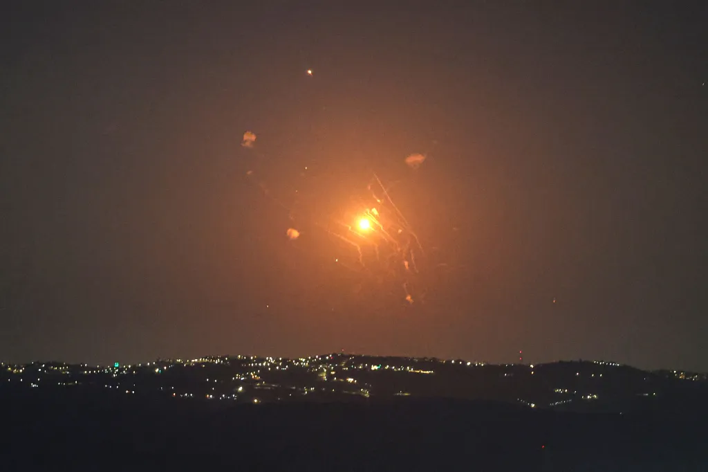 Jordanian air defense system intercepting Iranian missiles at night over the Jordan Valley.