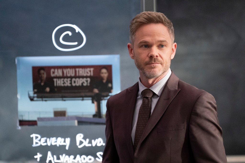 Shawn Ashmore as Wesley Evers in The Rookie, standing in front of a board displaying an anti-LAPD billboard and location notes.