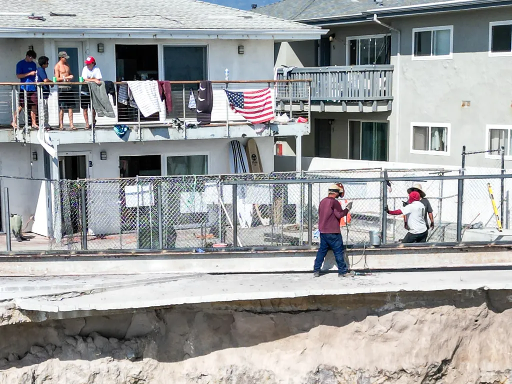 Apartments perched precariously on a collapsing cliffside in Isla Vista, California.