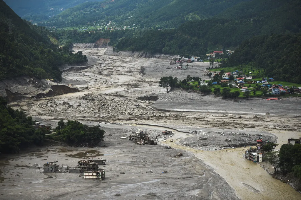 Aerial view of buildings near the Trishuli River in Betrawati Bazaar, Nepal, damaged and covered in mud after flash floods and a mudslide.