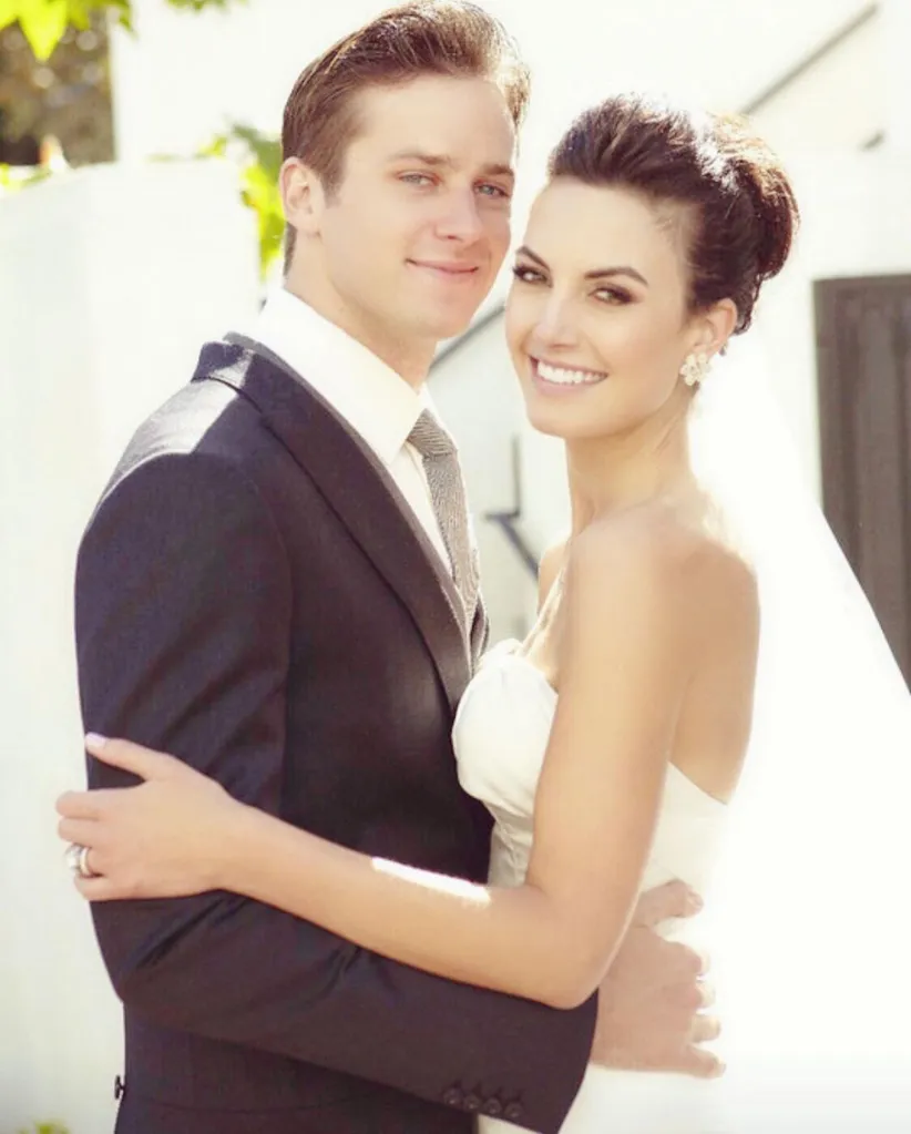 Armie Hammer and Elizabeth Chambers smiling and embracing in a wedding photo.