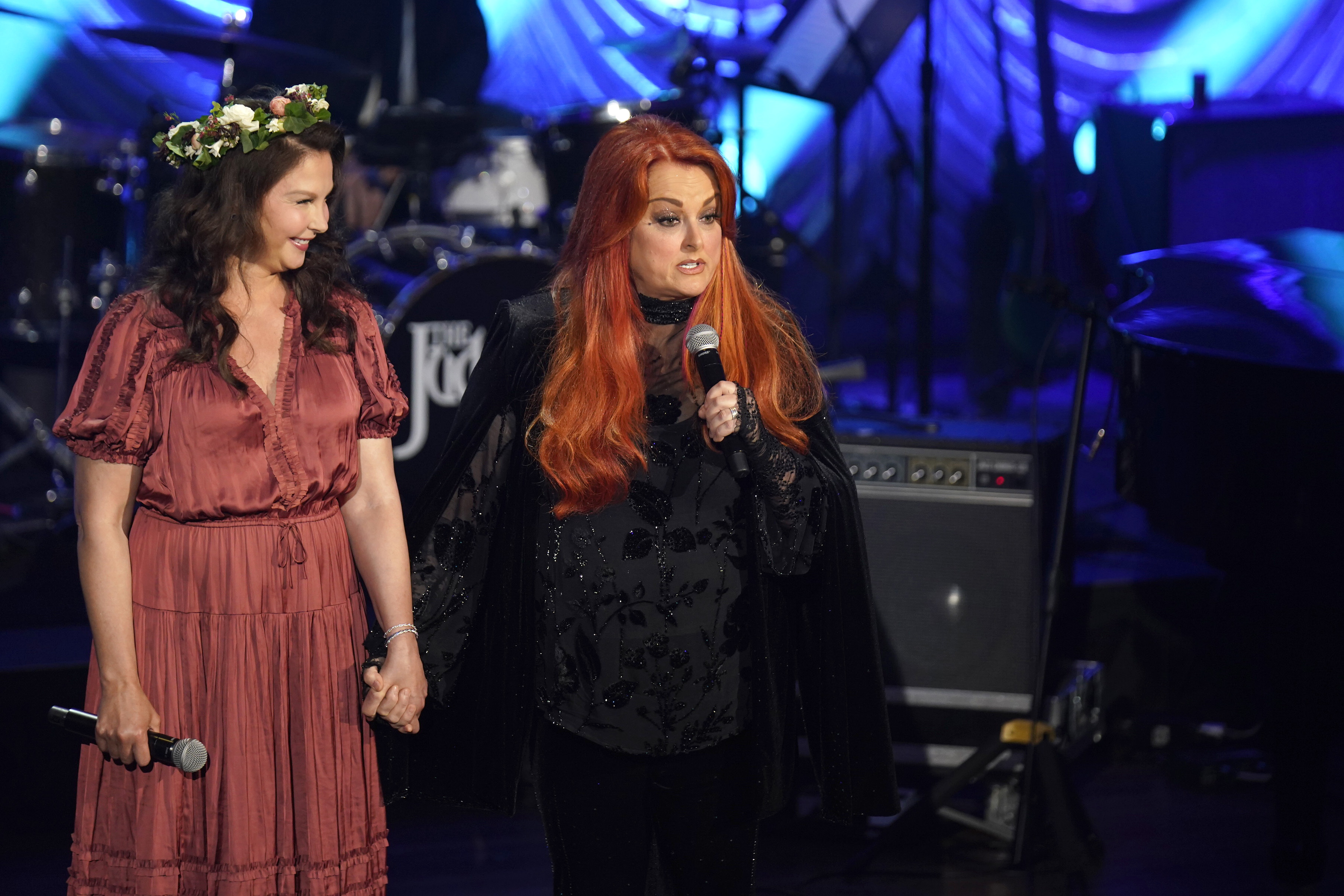 Ashley Judd and Wynonna Judd speak onstage during Naomi Judd: 'A River Of Time' Celebration at Ryman Auditorium in Nashville, Tennessee.