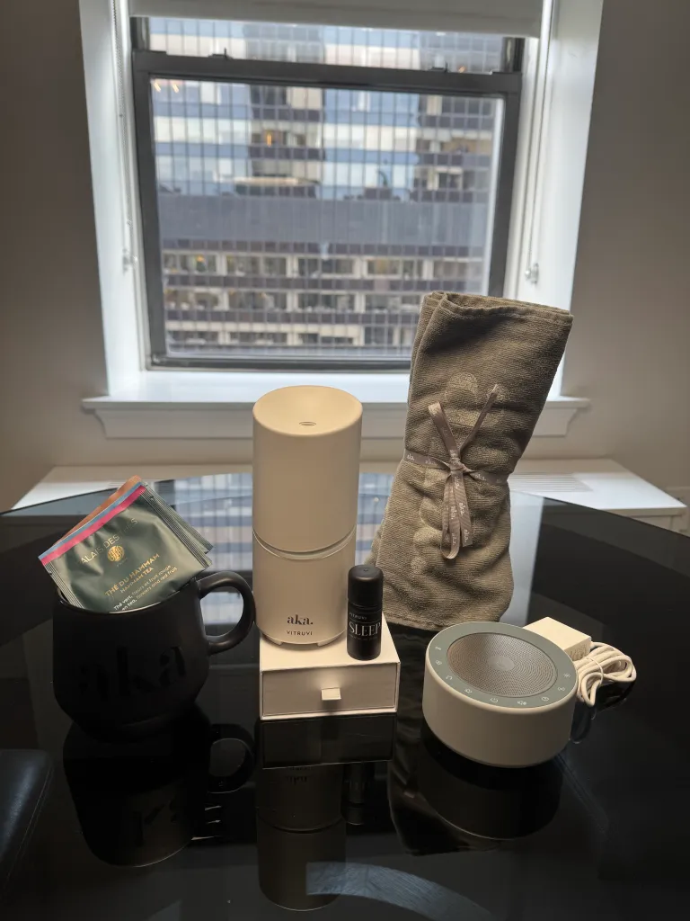 AKA Hotel's Atelier AKA Health + Wellness program elements on a black table with a city view.