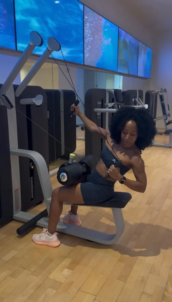 Patrice using a fitness machine to work her core as part of the AKA Hotel's wellness program.