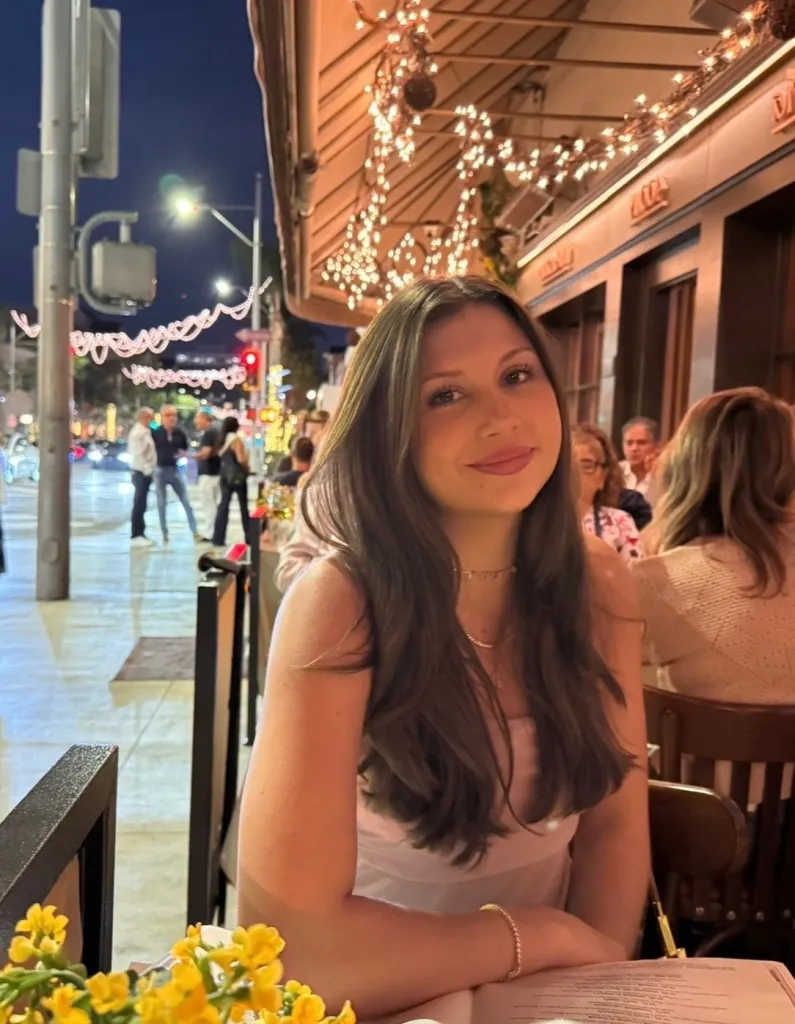 Ava Schmidt, a USC senior, sitting at a restaurant table.