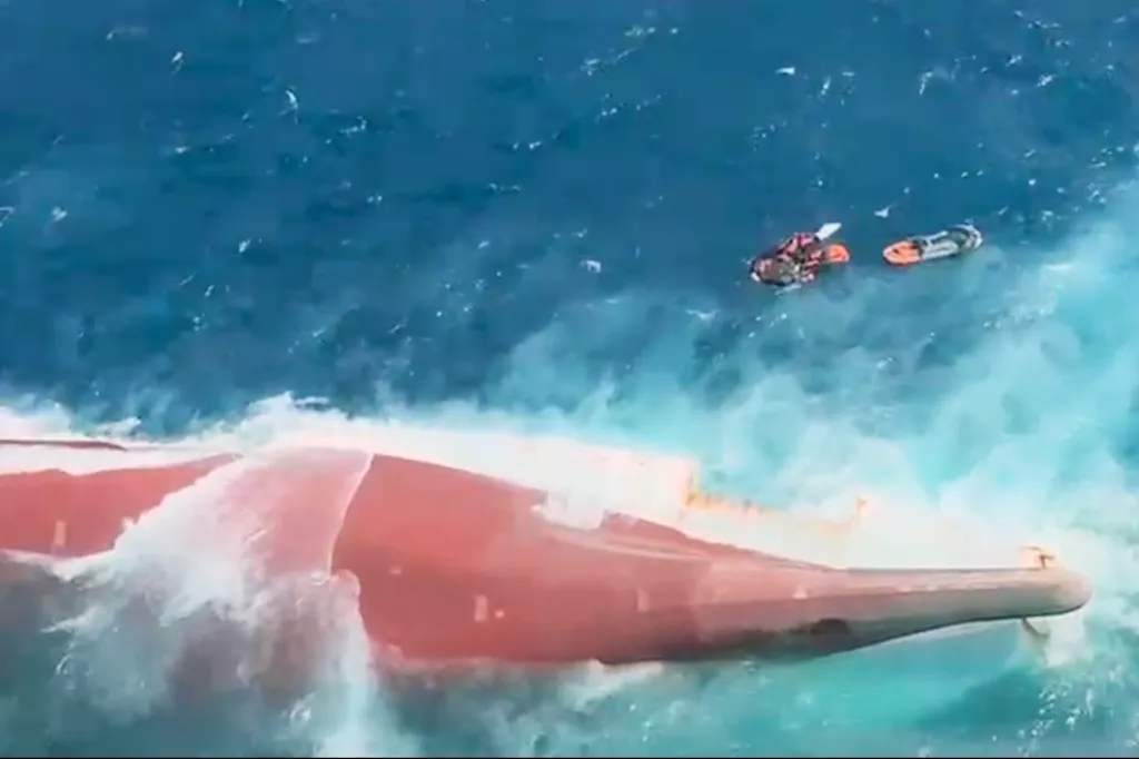 Aerial view of the overturned passenger ferry Virgo Transport 8 in the Java Sea, with two life rafts nearby.