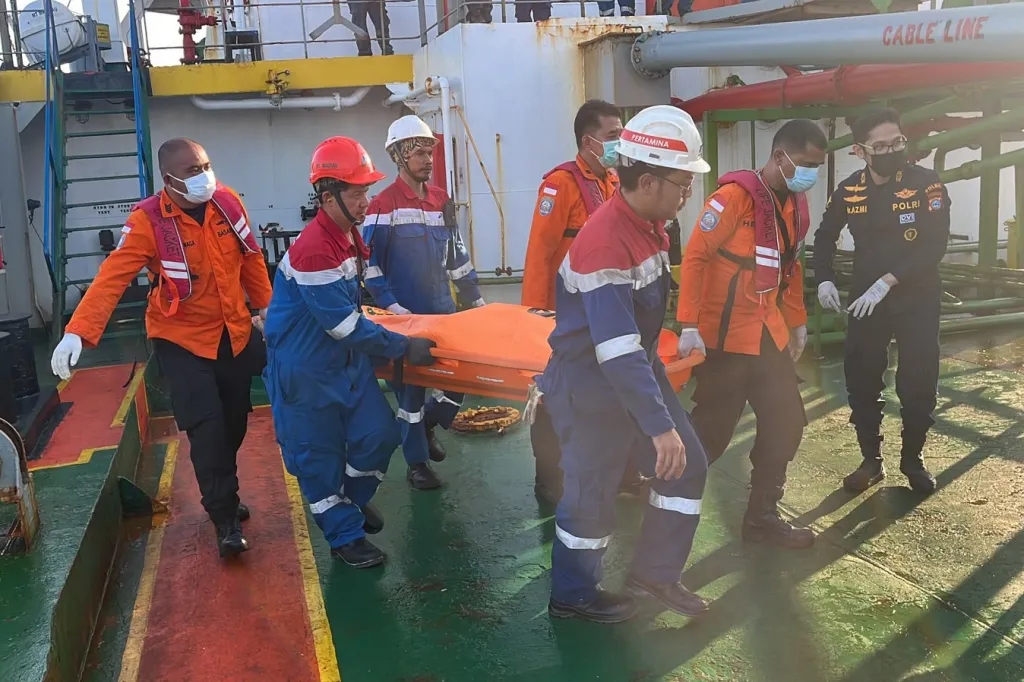 Rescuers carry a victim on a stretcher from a ferry accident in Banjarmasin, Indonesia.