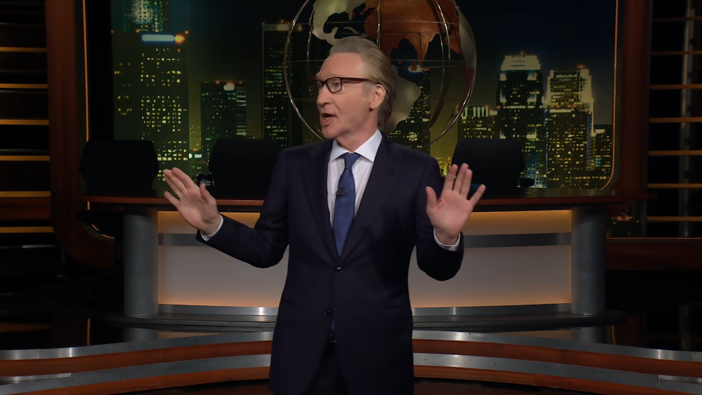Bill Maher speaking on a television set.