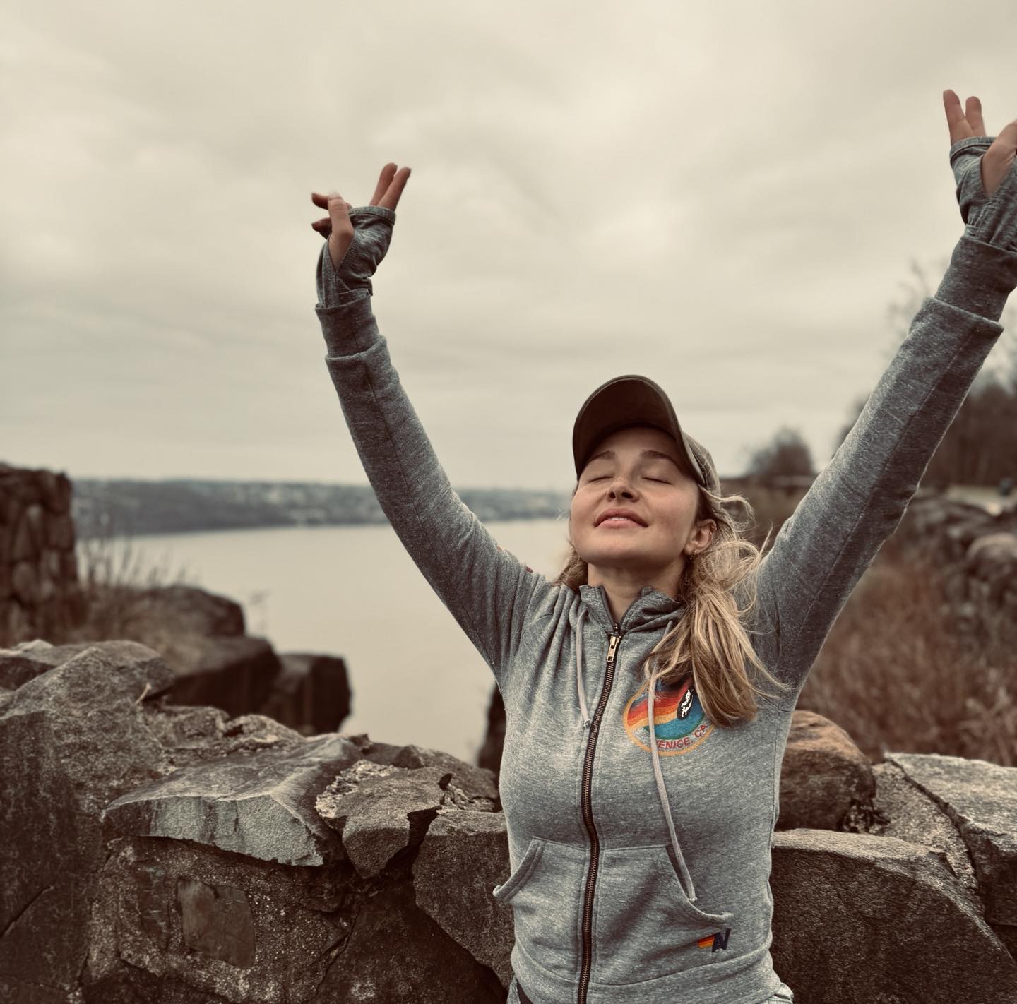 Hayden Panettiere with arms raised in victory.