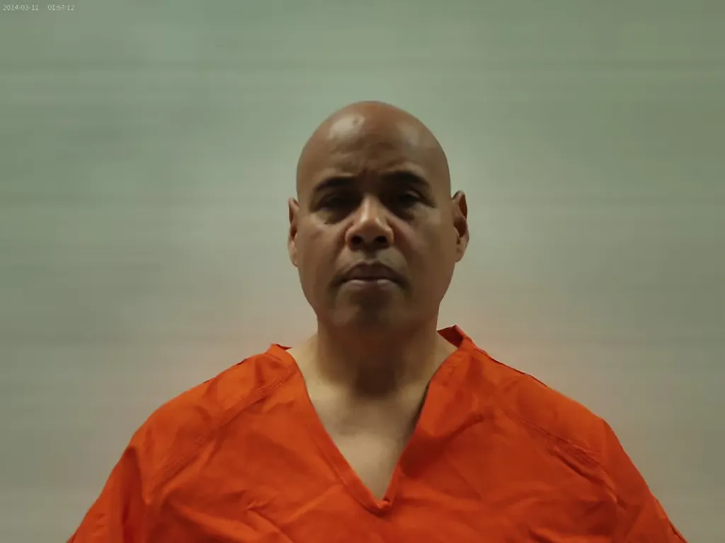 Booking photo of Christian Castro in an orange jumpsuit.