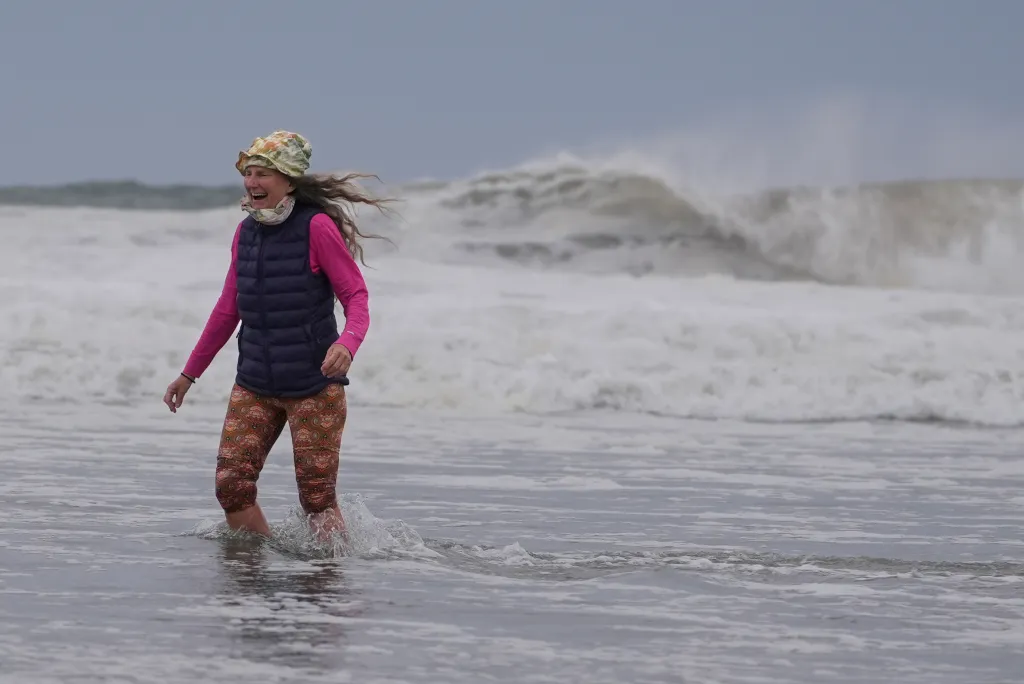 Massachusetts resident Brenda Malloy walks out of the water after she was caught by surprise by the rough surf from the incoming nor'easter on Sept. 25, 2026. 