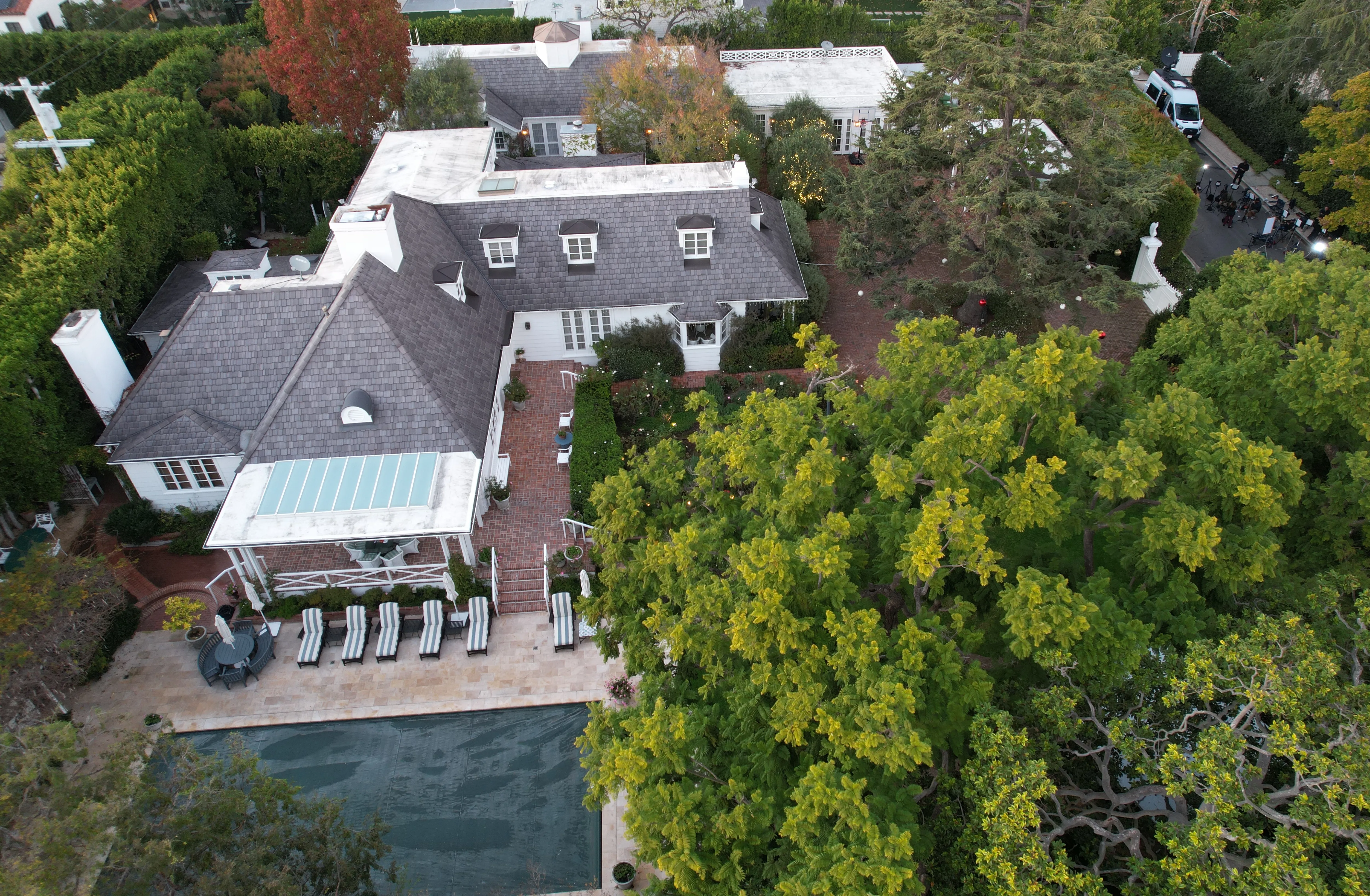 Aerial view of Rob Reiner's Brentwood, California home with a pool and lush trees.