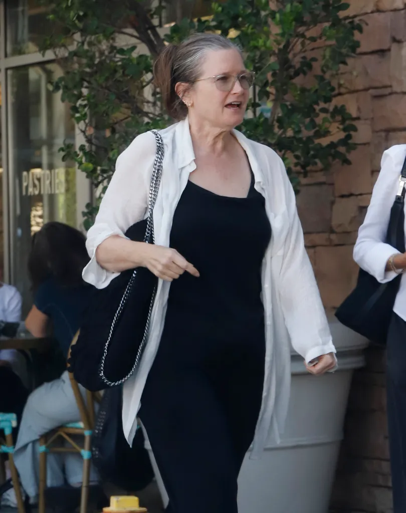 Bridget Fonda, in a white blouse, black top, and matching trousers, is shown stepping out in Los Angeles.