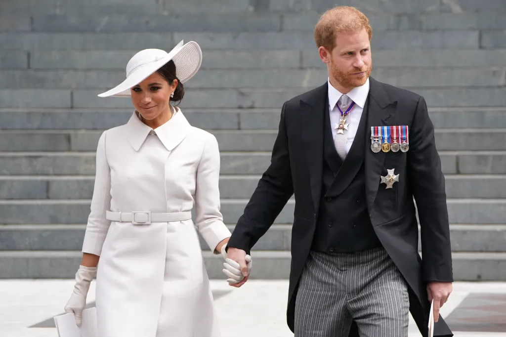 Meghan, Duchess of Sussex, and Prince Harry, Duke of Sussex, holding hands as they leave St Paul's Cathedral.