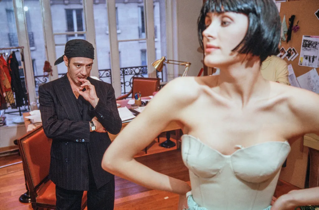 British fashion designer John Galliano during a fitting session with a fashion model.