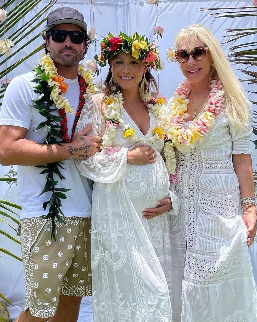 Brody Jenner and Tia Blanco pose with a woman at their baby shower.