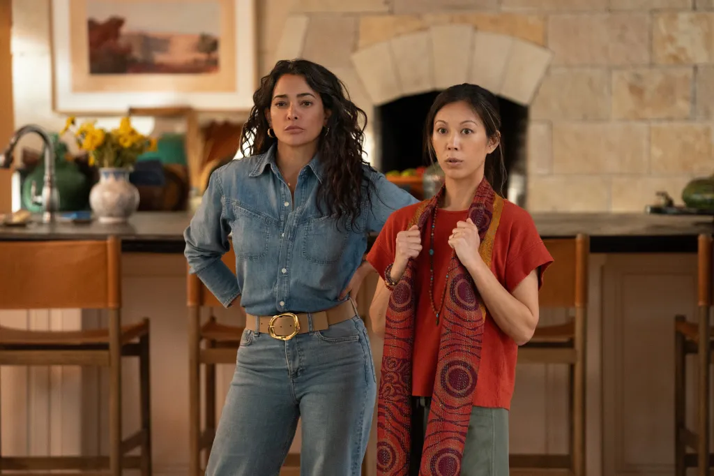 Two women standing in a kitchen, looking concerned.