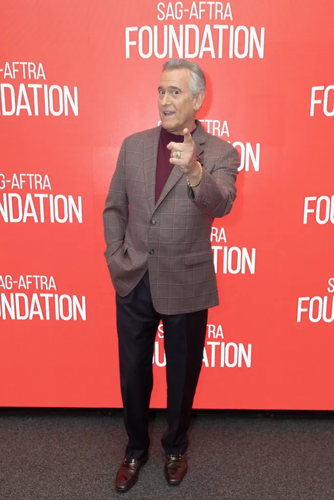 Bruce Campbell points at the camera in front of a red SAG-AFTRA Foundation banner.