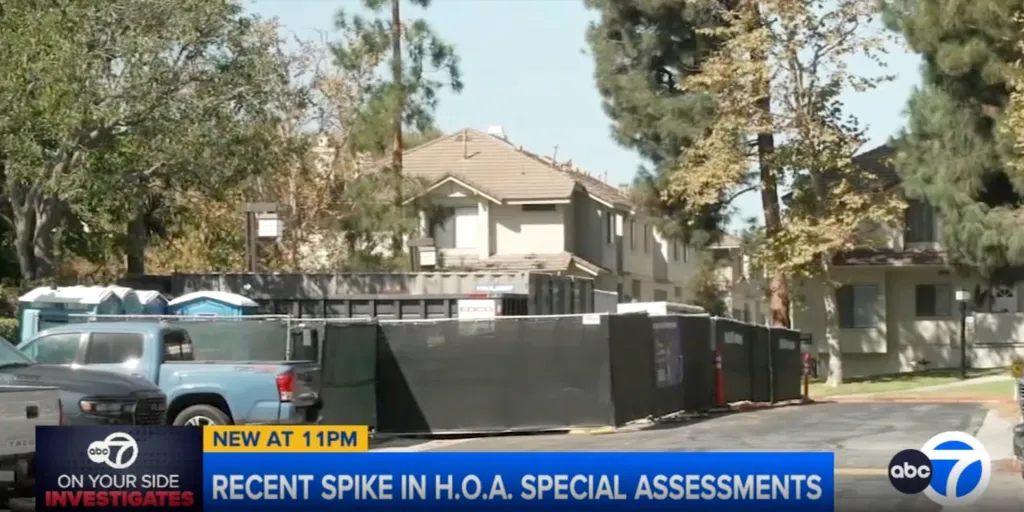 Construction site with apartment buildings in the background and a news banner about HOA special assessments.
