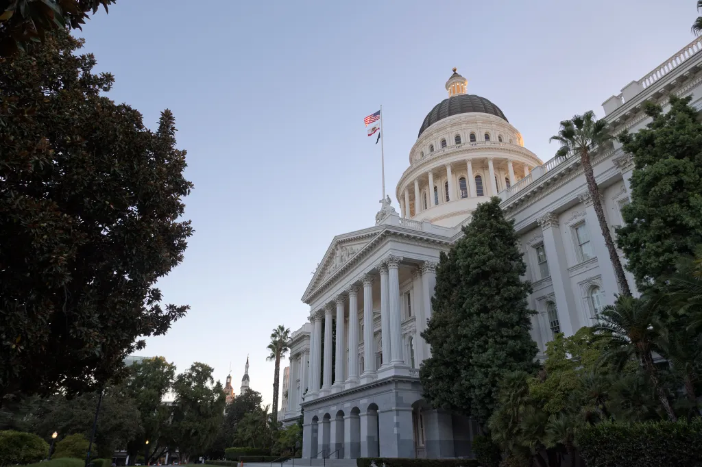 California's State Capitol Building in Sacramento at dawn, with the Cathedral of the Blessed Sacrament and The Elks Tower in the background.
