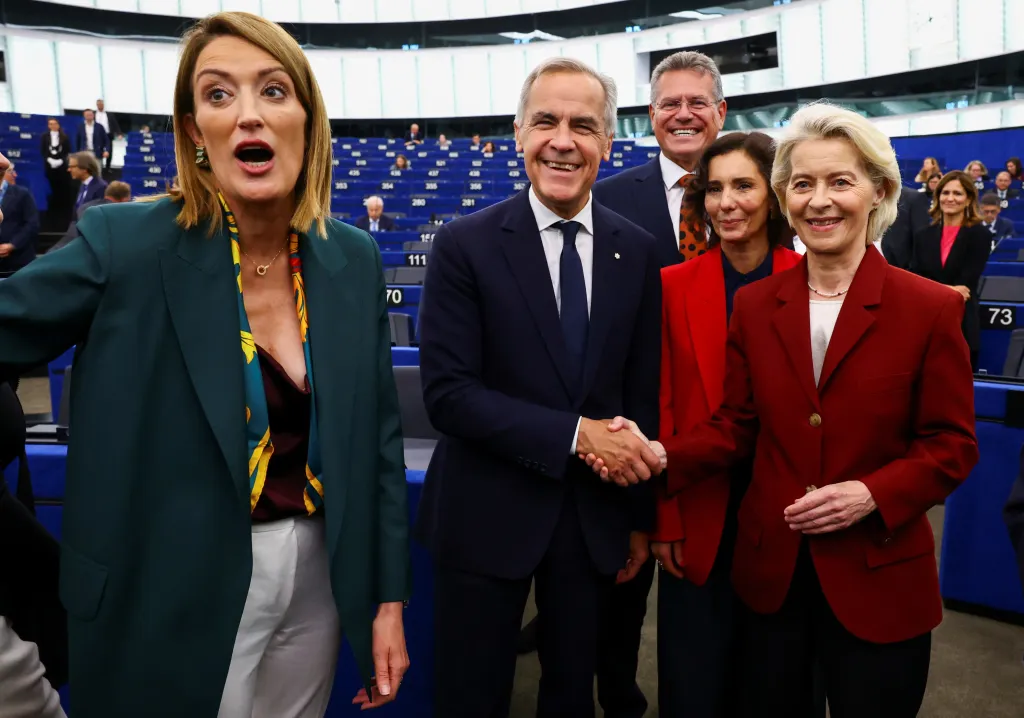 Canadian Prime Minister Mark Carney shakes hands with European Commission President Ursula von der Leyen as President of the European Parliament Roberta Metsola reacts.