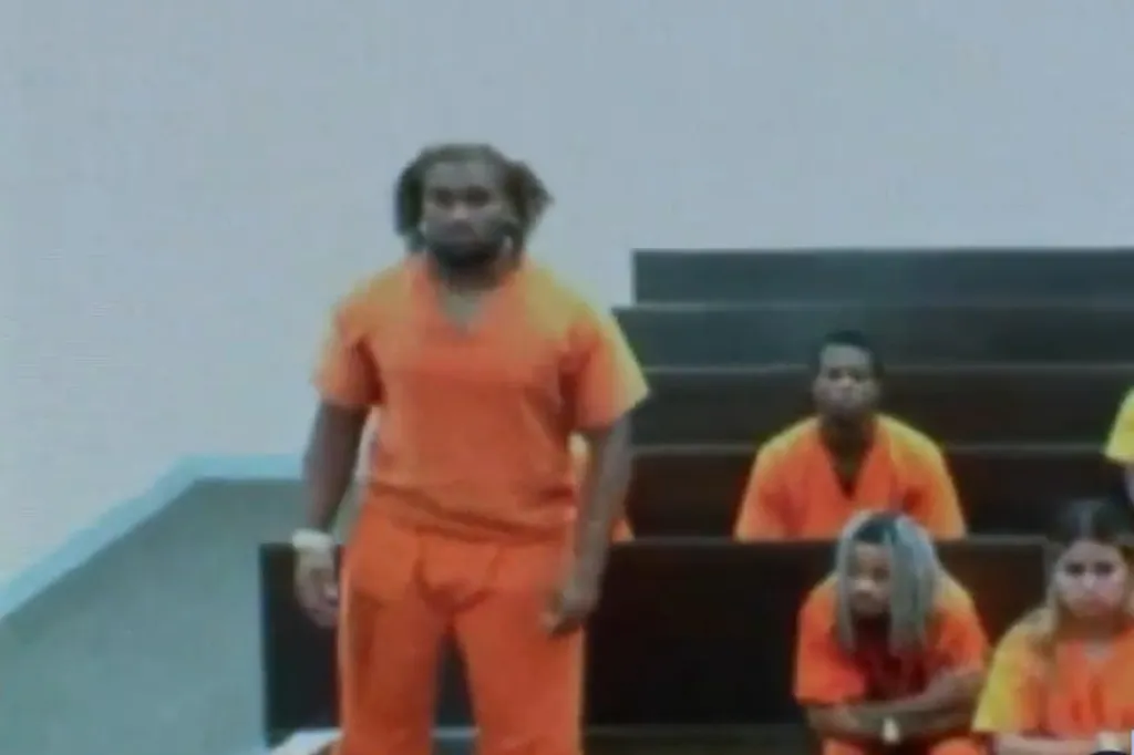 Carmello Brooks in court wearing an orange jumpsuit.