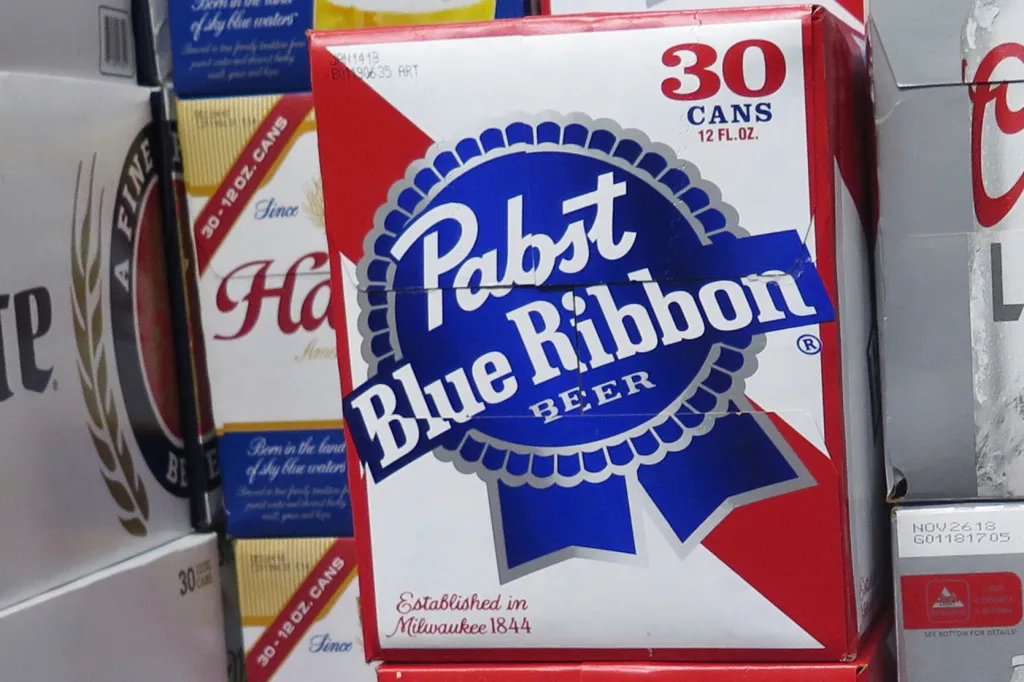 Cases of Pabst Blue Ribbon beer are stacked in a liquor store.