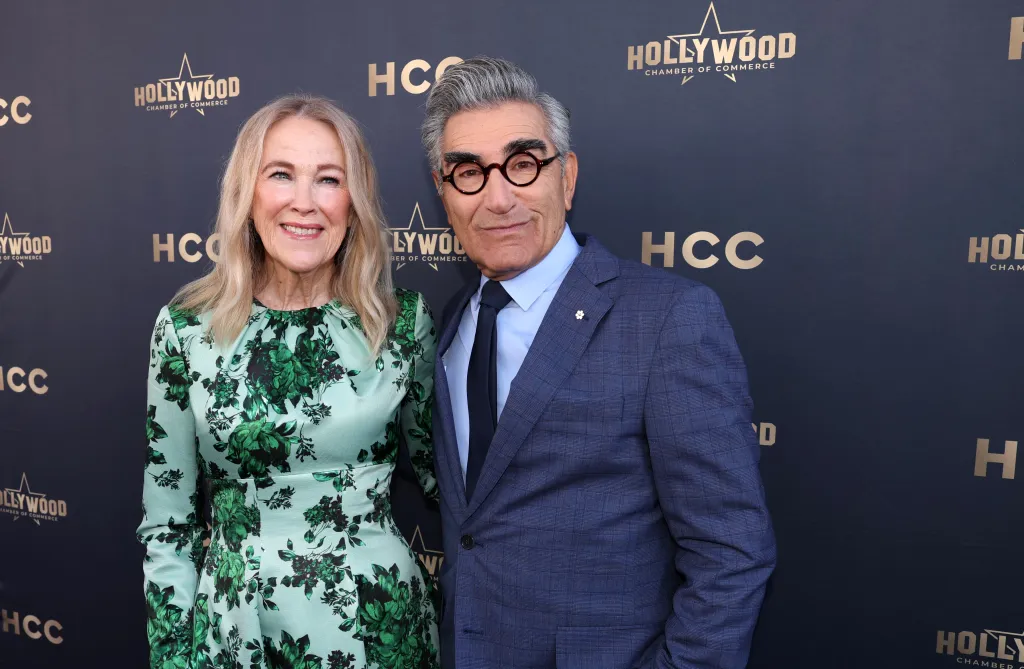 Catherine O'Hara and Eugene Levy pose together on a red carpet with 