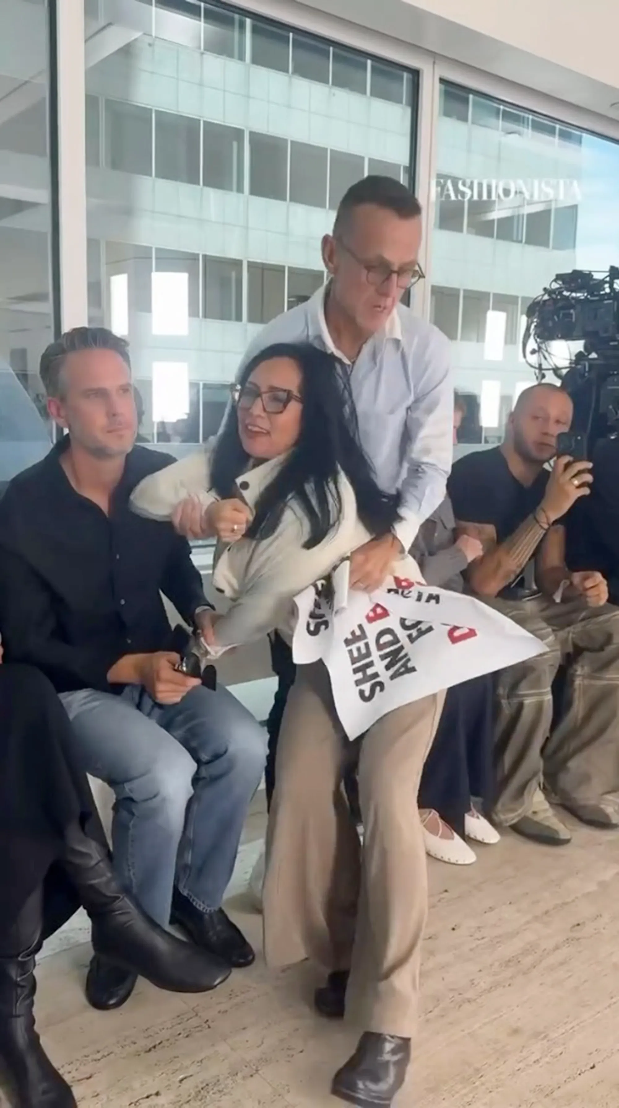 Steven Kolb tackling a PETA protestor at a runway show.