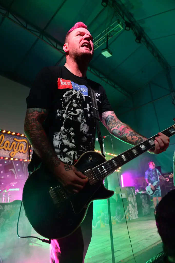 Chad Gilbert of New Found Glory playing electric guitar on stage.